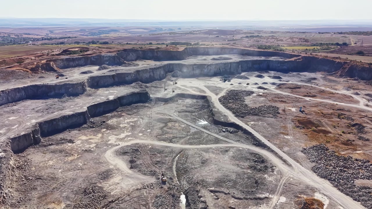 Granite quarry operation near a landscape with hills and clear skies during daytime