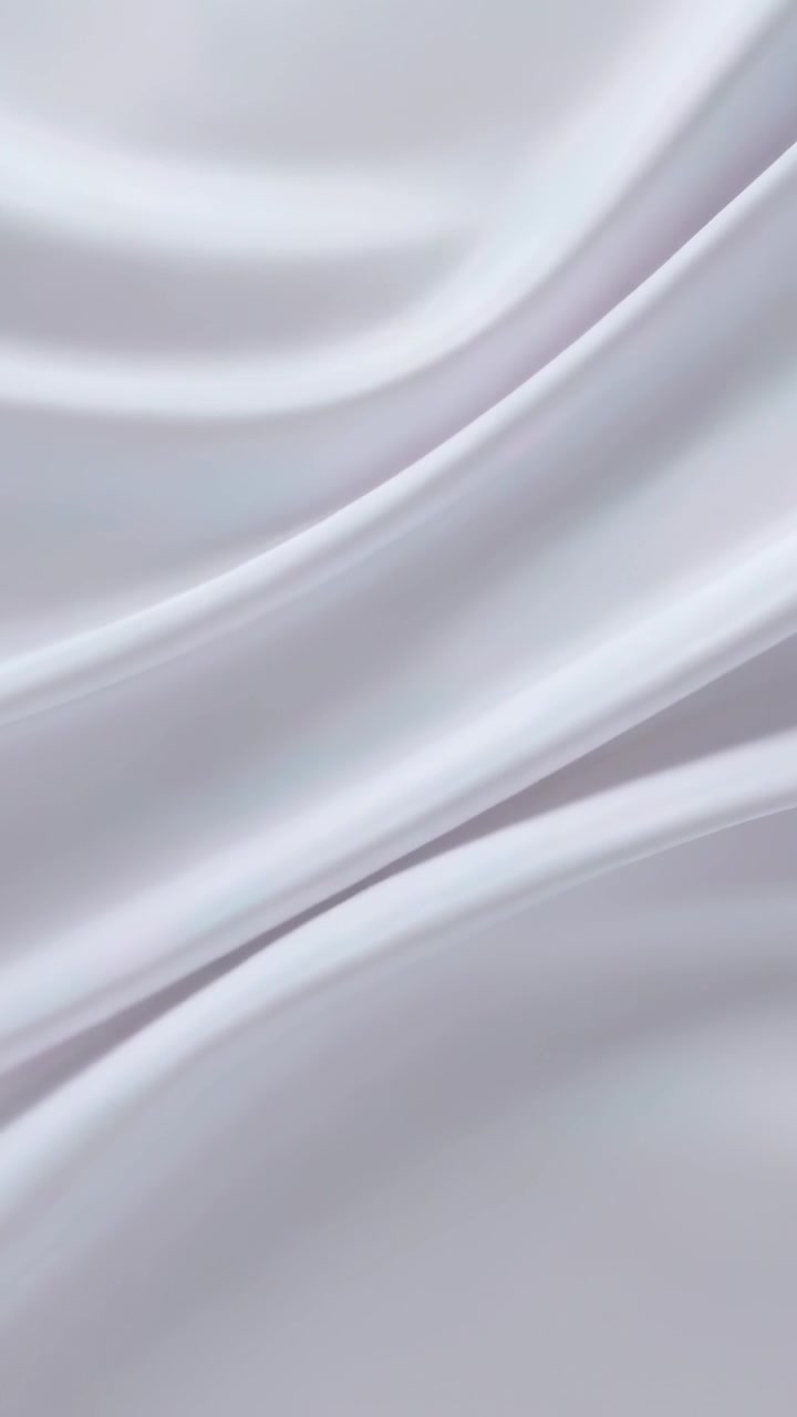Vertical video: Panning camera showing satin fabric folding on set for catalog with soft light