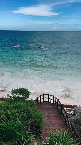 tropical beach with boats and wooden walkway