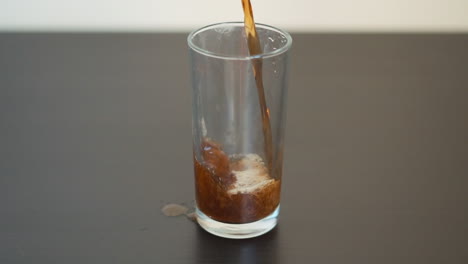 slow motion man pouring soda into a glass