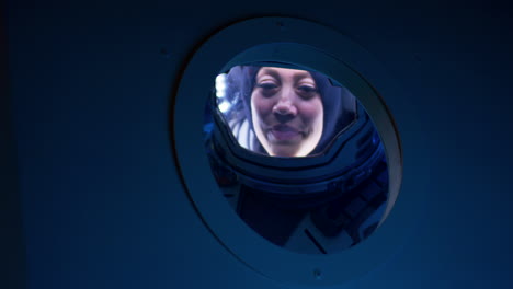 astronaut in spacecraft window