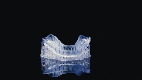 ultraviolet model of teeth rotating against black background