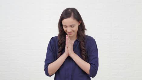 cute indian girl doing namaste