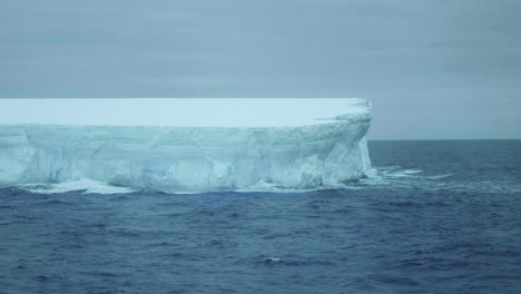 close up of a tabular iceberg on a cloudy day