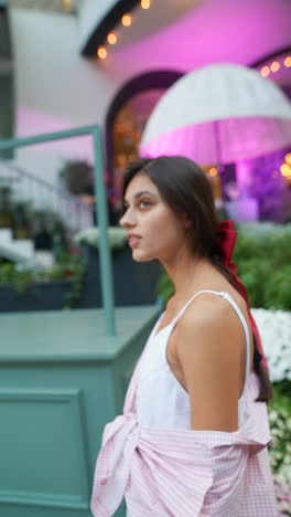 woman in pink shirt and red ribbon