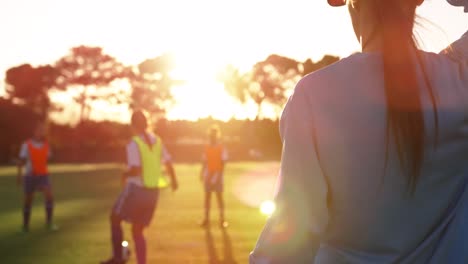 rear view of diverse female soccer team training 4k