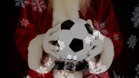 Santa-Sosteniendo-Una-Pelota-De-Fútbol-En-Copos-De-Nieve