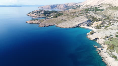 aerial of deep blue see surrounding krk island coastline in baska, croatia