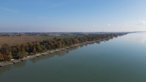 panoramic aerial overview of blenheim lake erie shoreline with erosion control measures and trees reflected in water