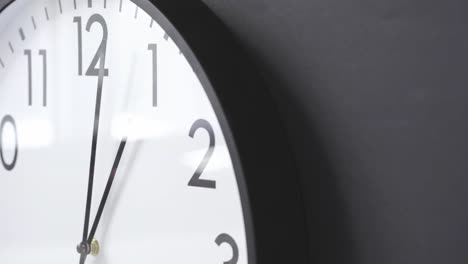 simple clock hanging on black wall close up