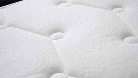 close-up of a white tufted mattress