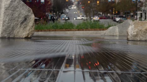 timelapse of traffic reflecting in flowing waves of water