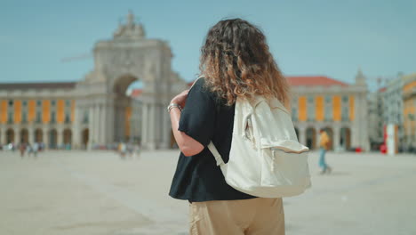 woman with backpack in lisbon square