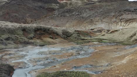 paso elevado de drones bajos río islandés terreno montañoso rocoso con niebla y rocas