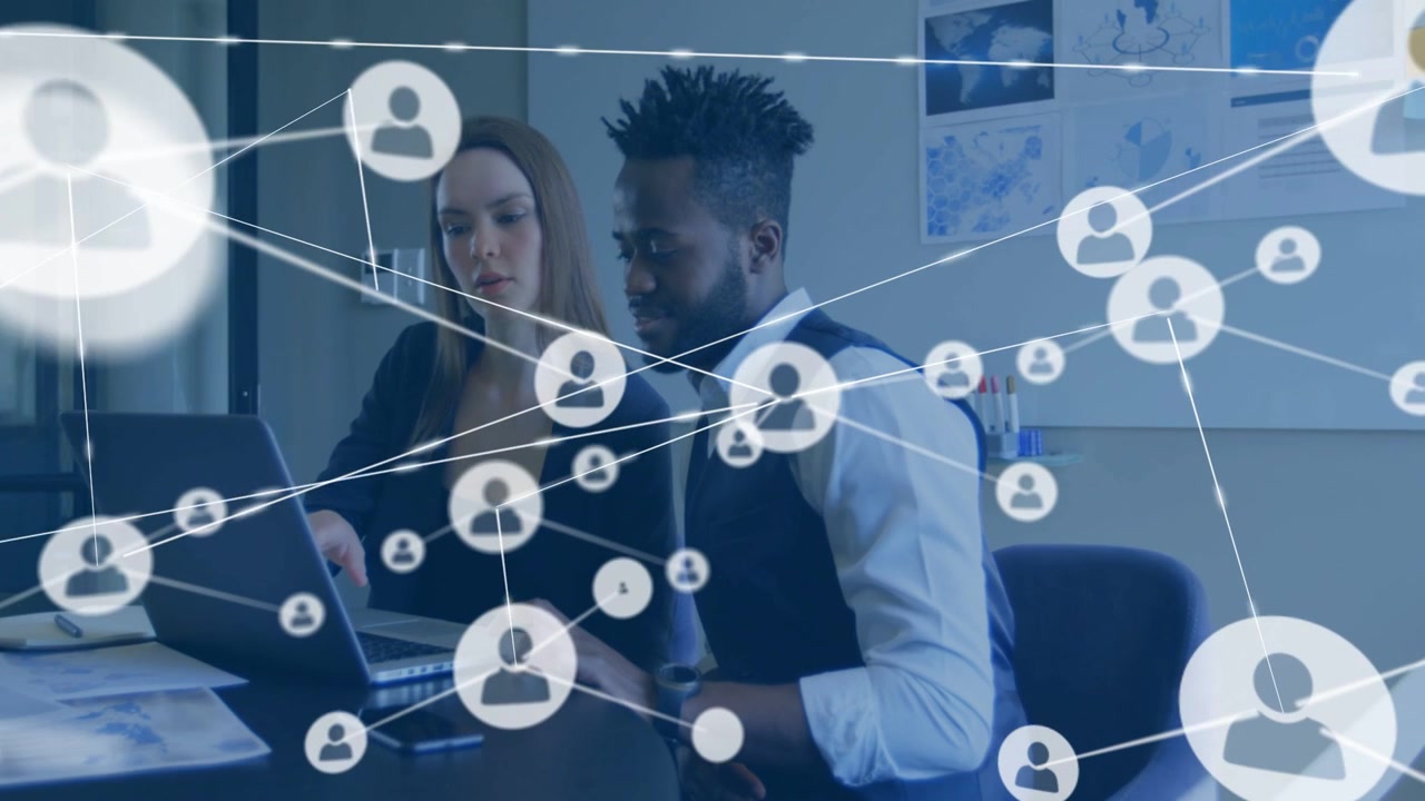 Woman pointing at laptop man using controls causing data network overlay growing reviewing business