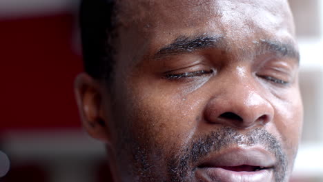 close-up of an african american man's face, showing sweat and emotion