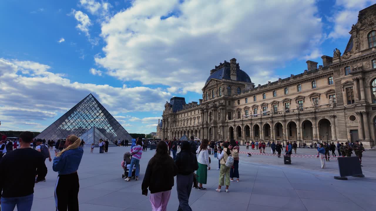 Louvre Pyramid museum square Paris France tourist attraction busy during the day