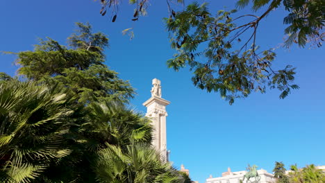 historical statue towers above lush greenery - monumento a la constitución de 1812