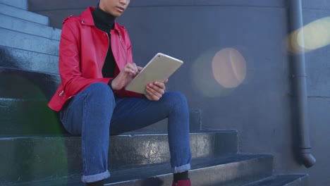 Transgender adult using a digital tablet in the street