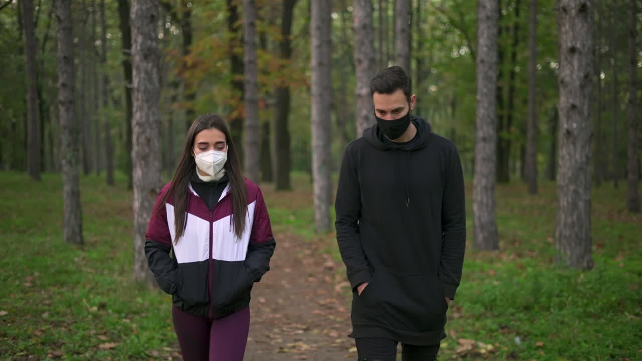 People walking in the forest wearing masks
