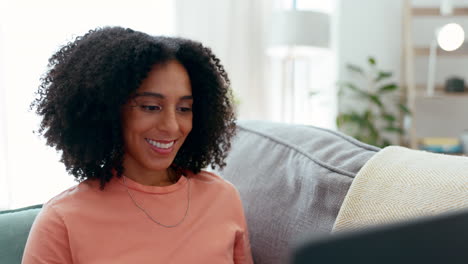 Laptop,-smile-and-woman-typing-on-sofa-in-home