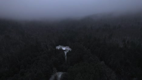 aerial drone video footage of a beautiful snowy, foggy evening with low clouds in the appalachian mountains during winter