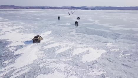 drone view of cinematic car racing on top of the frozen lake baikal amazing nature movie scene