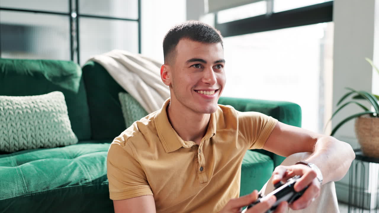 Man playing video games on couch