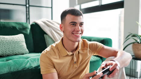 man playing video games on couch