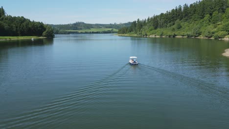 a small pleasure motorboat sailing on a natural lake