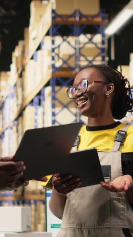 vertical video african american staff checking inventory and shipment details