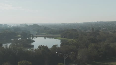 Drone-aerial-of-a-Falcon-sitting-on-spotlight-tower