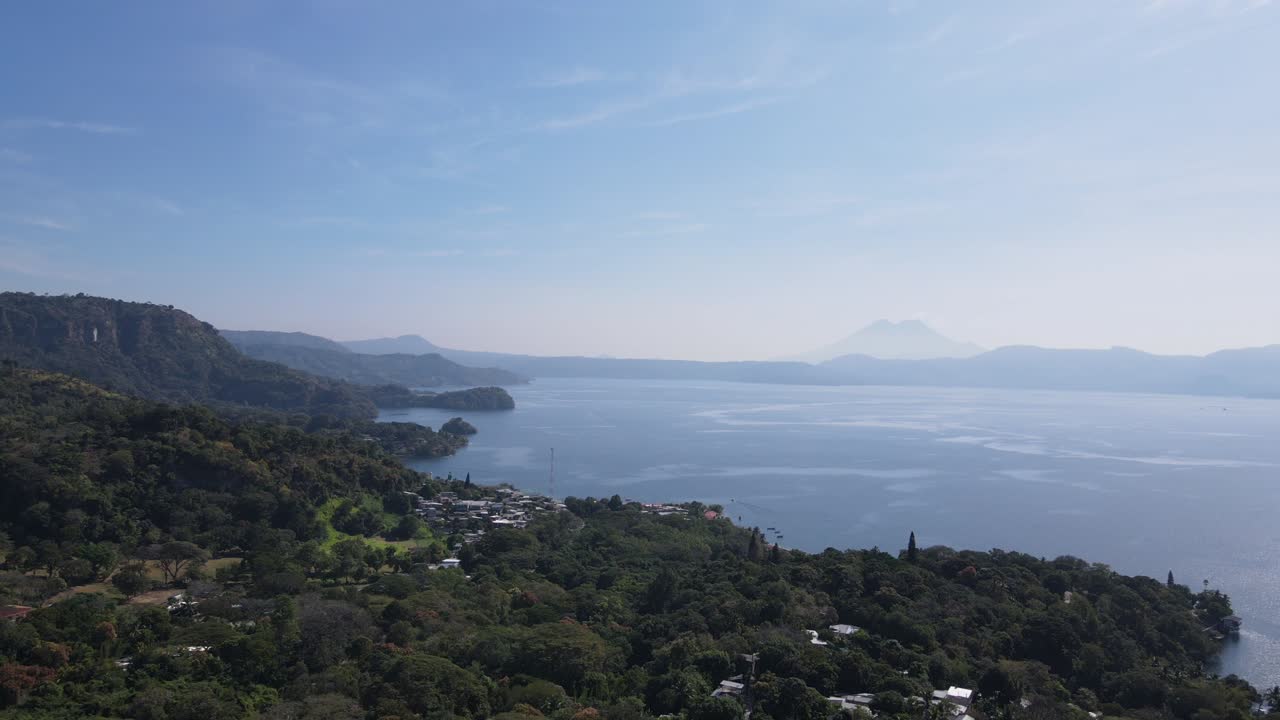 Views of the beautiful Ilopango Lake in El Salvador, with mountains and volcanoes in the background and a beautiful sky