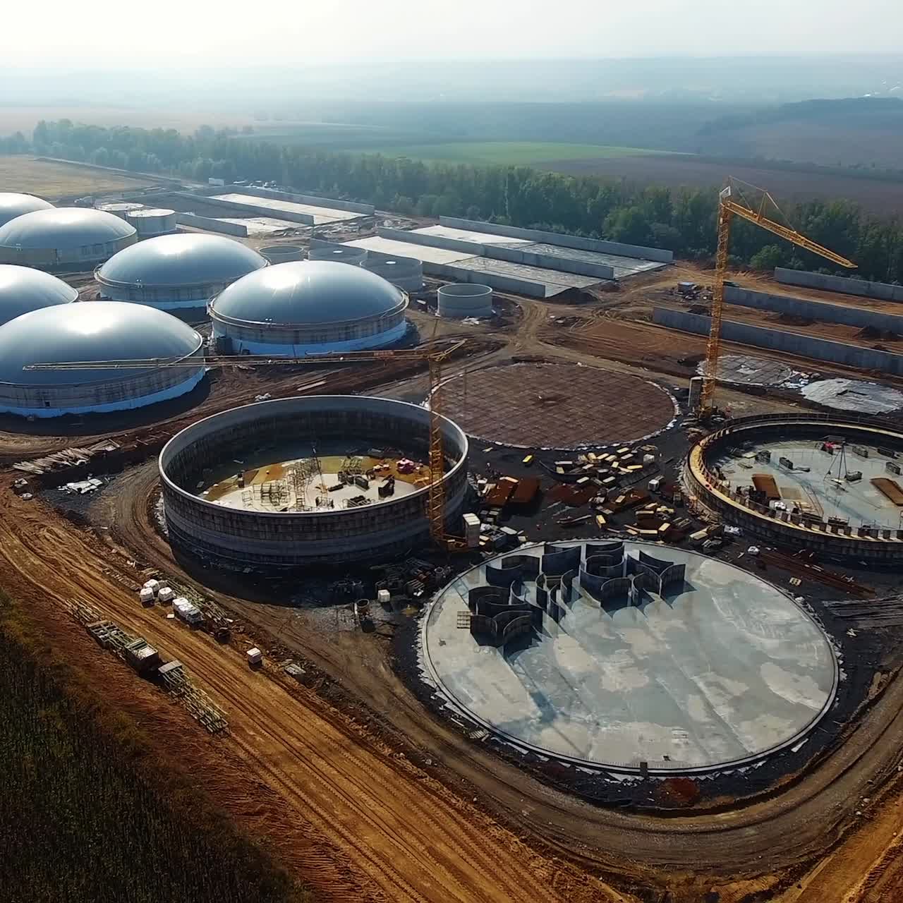 Round roofs of bio gas station. View from above. Factory out of town. Modern plant building. Ecological production