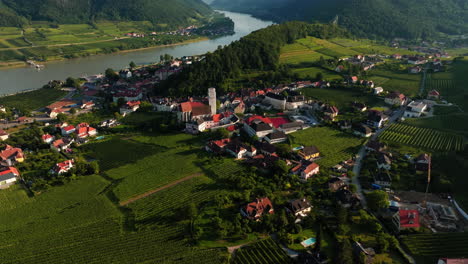 panoramic aerial orbit above idyllic countryside town of spitz, austria in fertile wachau valley