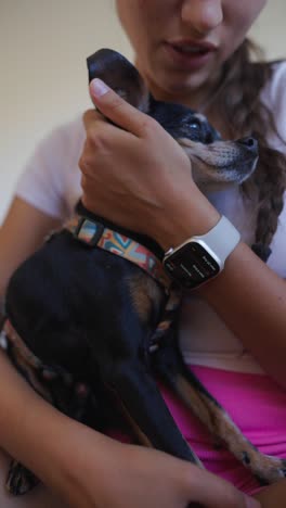 woman holding her small dog