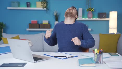 Young-man-working-from-home-too-much-gets-tired-and-his-neck-and-back-aches.-It-does-neck-and-back-exercises.