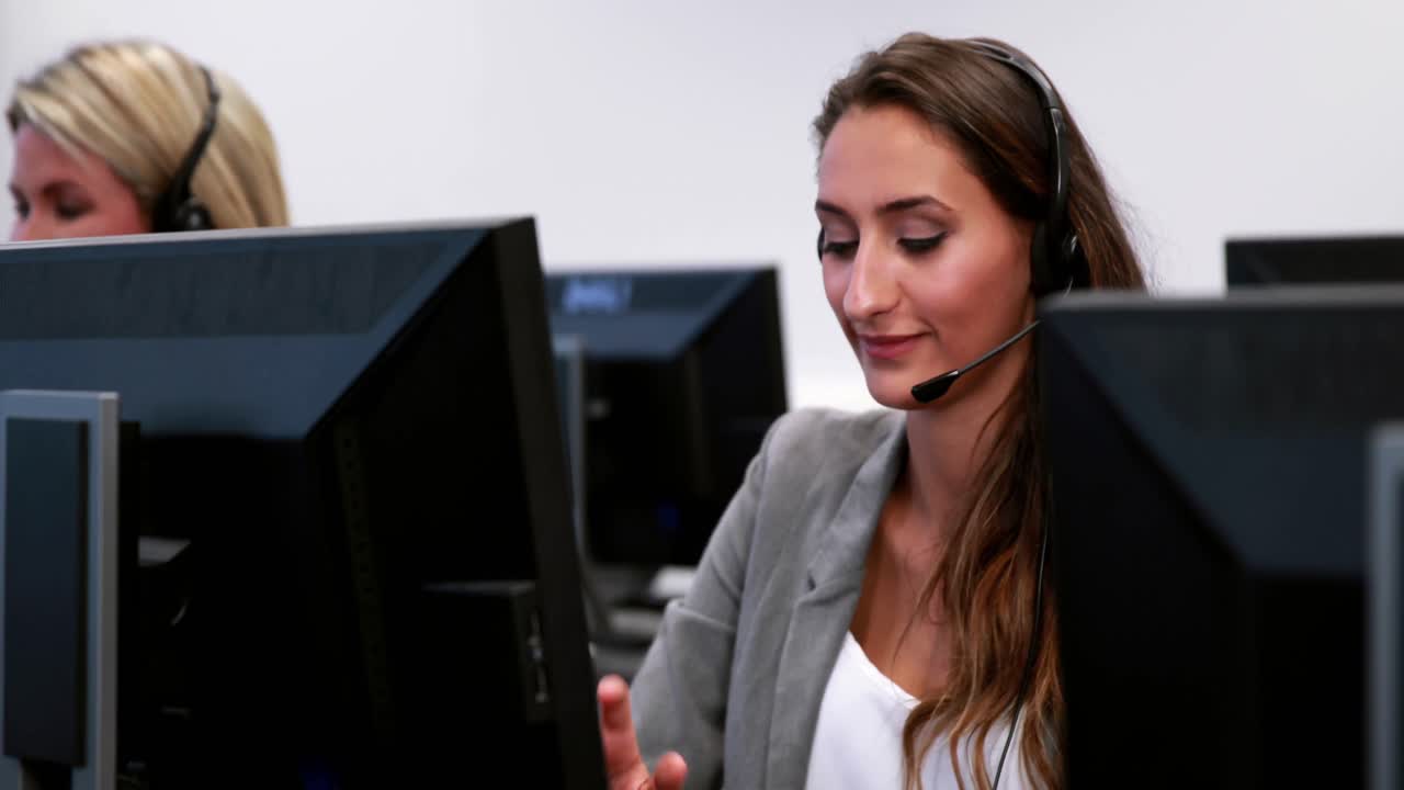 Smiling call centre agent talking on the headset