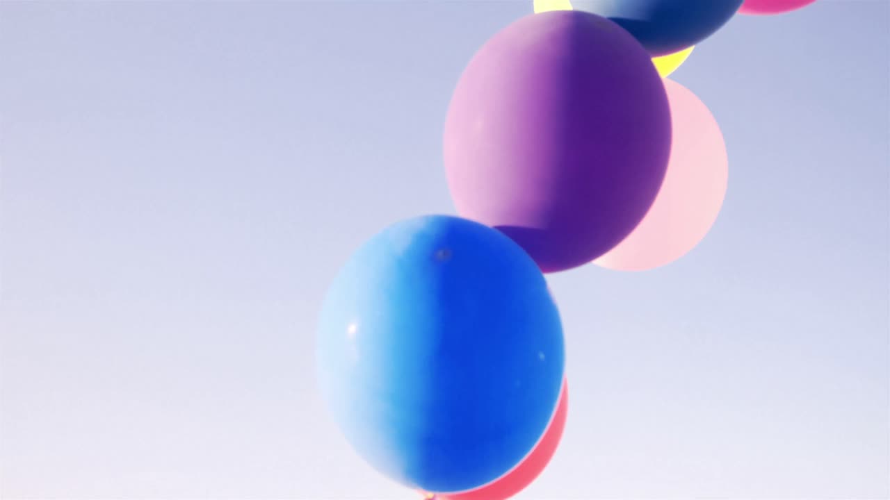 Young girl holding balloons