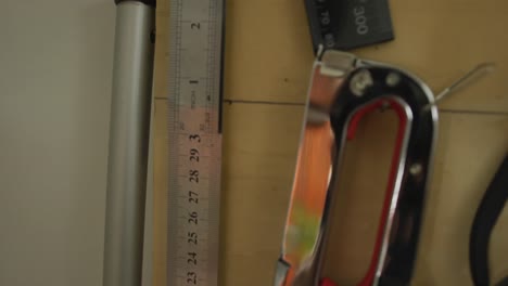 diverse tools and measures hanging on wall in leather workshop