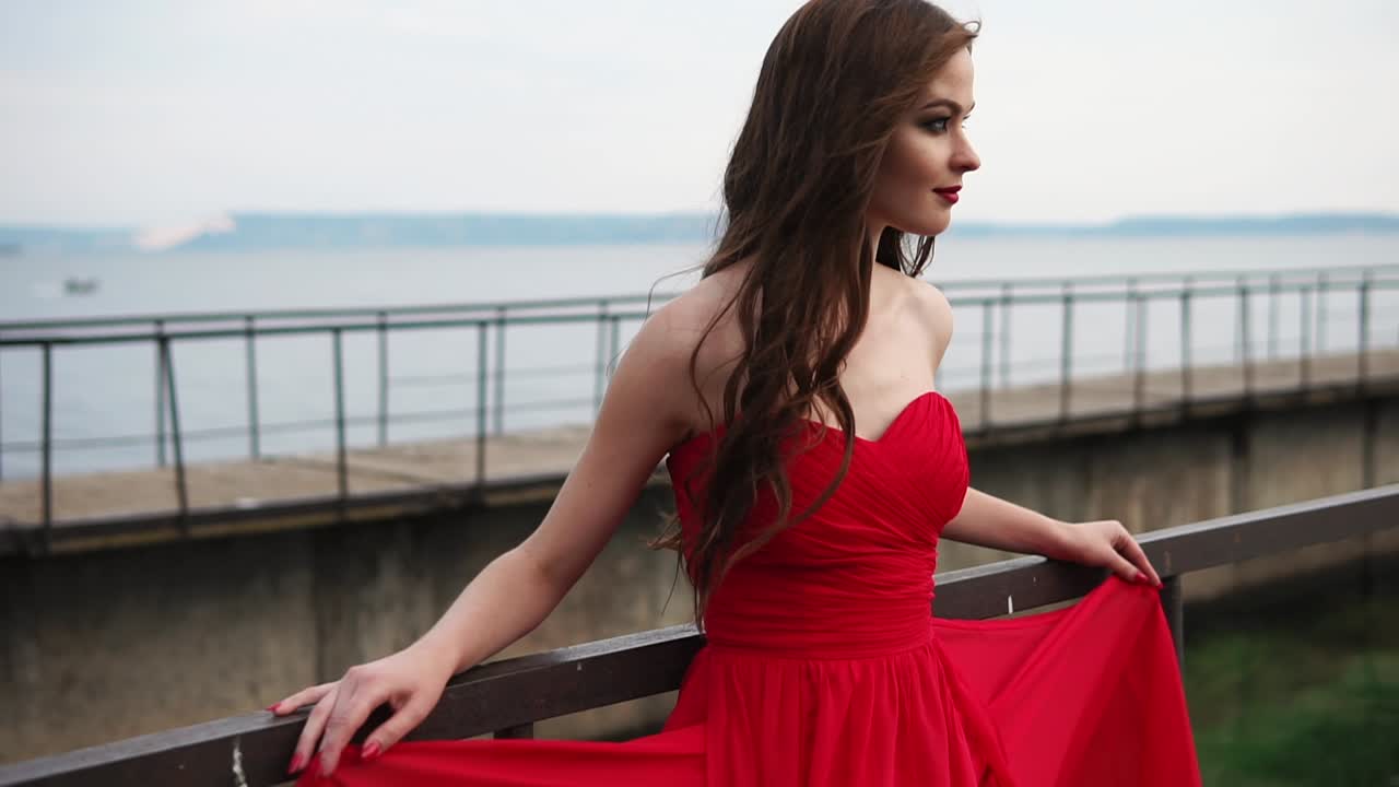 Woman in Red Dress by the River