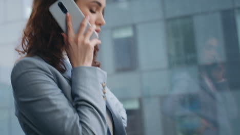 company worker answering call at office window close up. girl talking telephone