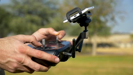 close up view drone pilot operating professional quadcopter