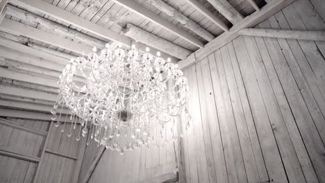 gorgeous reveal of a wedding gown in a light filled white room with a elegant crystal chandelier