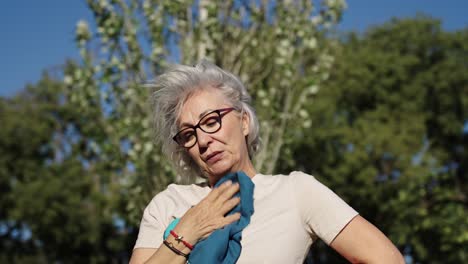 senior woman resting after exercise outdoors