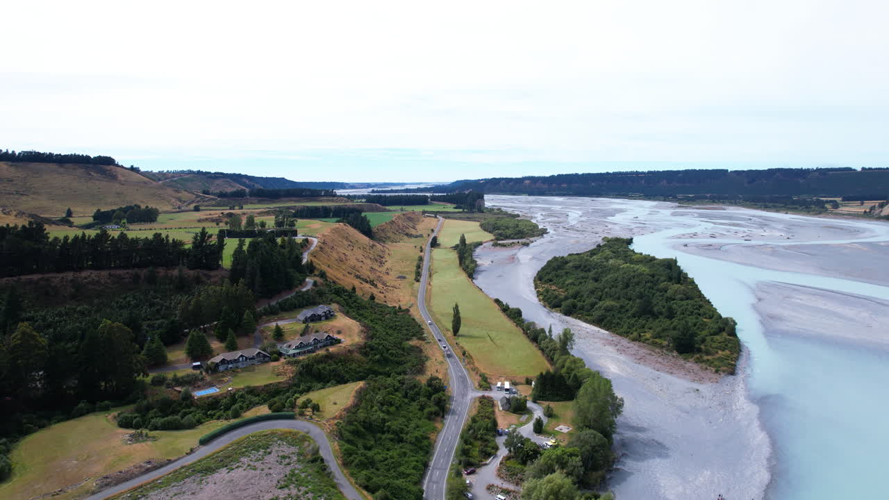 Aerial view following traffic on a road at the Rakaia Gorge river, in New Zealand