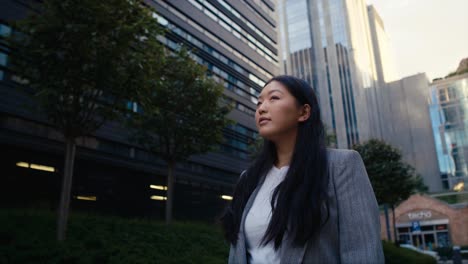 business chinese woman walking the city street