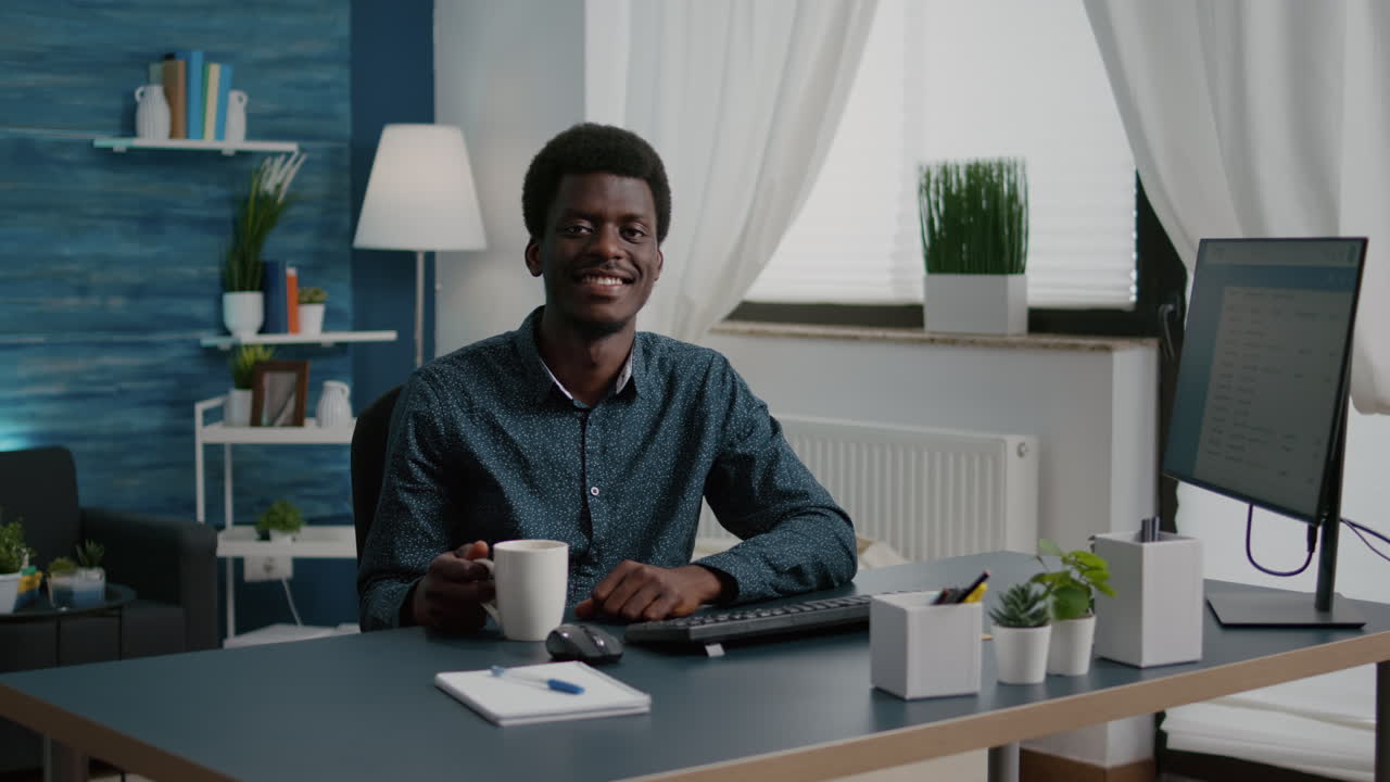 Zoom in shot on african american black man freelancer smiling into the camera