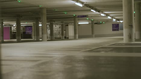 lights becoming bright in empty underground parking lot in metzingen, germany, baden wurttemberg, europe, panning view angle