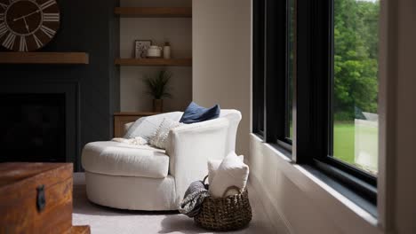 panning medium shot of a white modern chair in a sunlit living room